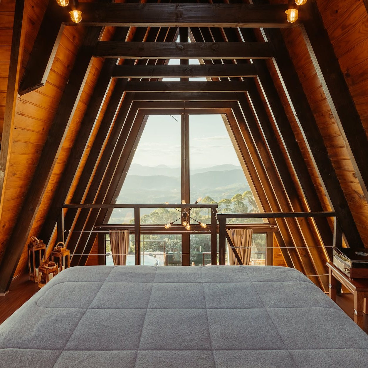wide bed in a luxury wooden cabin with a scenic mountain view, cleaning company in bellingham washington